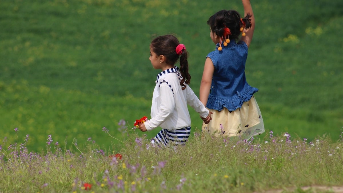 girl in white dress standing on purple flower field during daytime